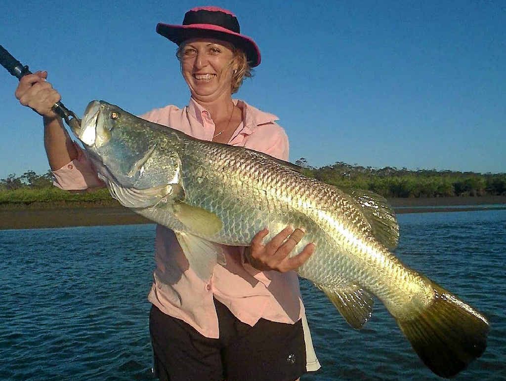 Nicole Price holding up a solid barra before it was later released. Nicole Price holding up a solid barra before it was later released.